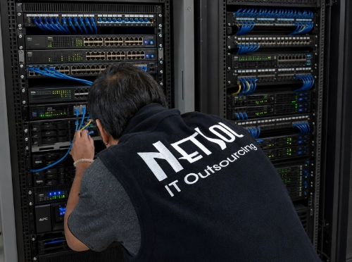 NetSol technician working on network switches during onsite IT support